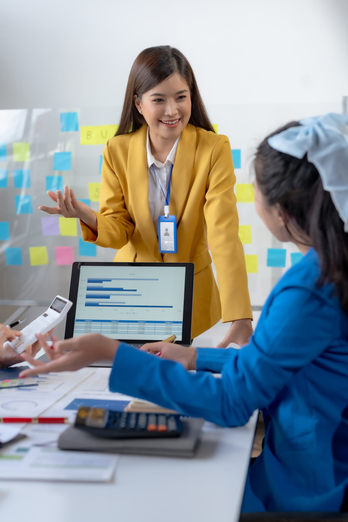 A manager talking with a colleague over a laptop in a planning session